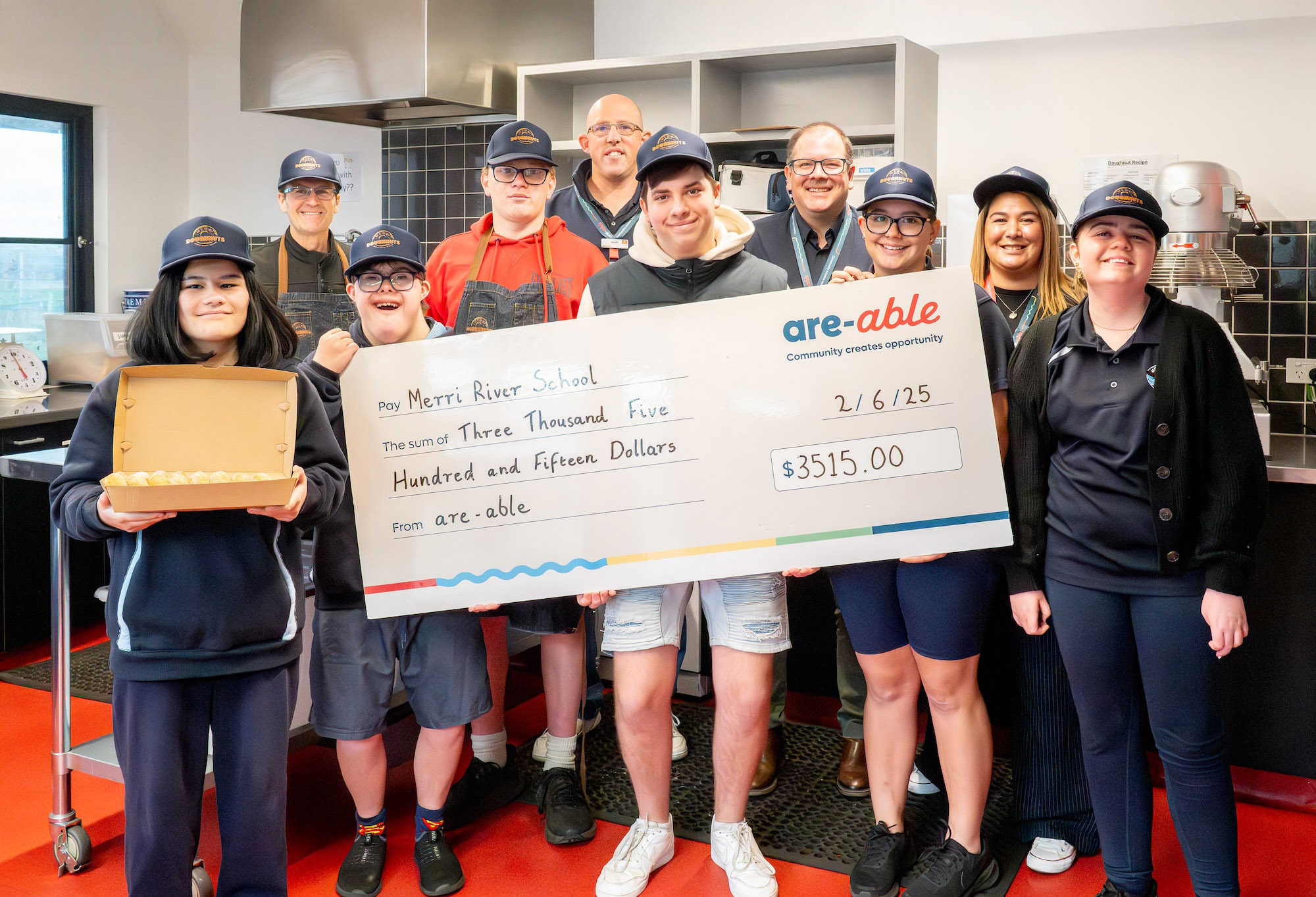 Students from Merri River School proudly accept an are-able Foundation grant to grow their Merri Doughnuts enterprise and build real-world skills.